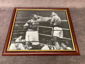 A framed photograph of Mohammad Ali and Joe Frazier with both autographs. Frame Size 57 x 48cm