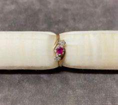 A 9 carat gold ladies ring set with illusion diamonds and ruby, size R total weight 2 grams