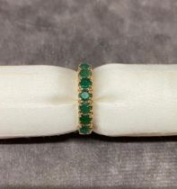 A 9 carat gold ladies ring set with 7 Emeralds, size M, 2.4 grams