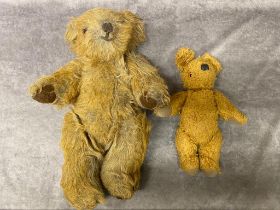 Two antique jointed teddy bears, the smaller of the two contains a bell