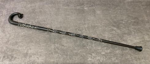 An antique Chinese ebony walking cane in the shape of a Dolphin with mother of pearl embellishments