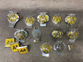 A collection of vintage AA car badges