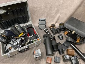 A metal case of camera equipment and other lose camera equipment, with 7 lenses