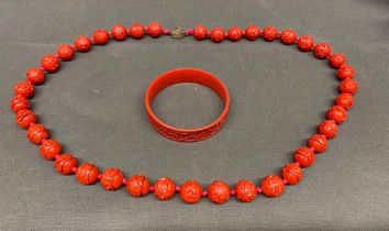 A Cinnabar necklace and bangle