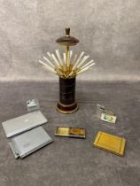 A vintage musical cigarette dispenser along with other smoking paraphernalia