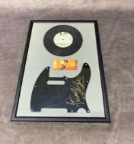 A framed signed pickguard by Shirley Bassey together with a 7 â€œ single of Diamonds are forever