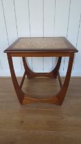 A mid century side table with tiled top