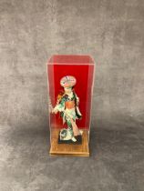 A vintage geisha girl doll in case