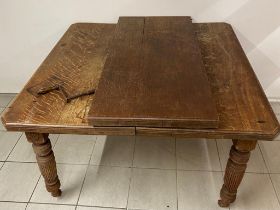 A large antique oak winding extending table