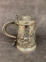 A early solid silver tankard possibly 1719 with later embellishments