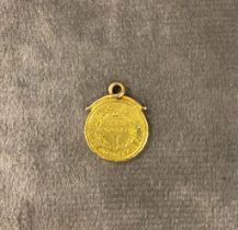 A 1853 American gold dollar 1.8 grams