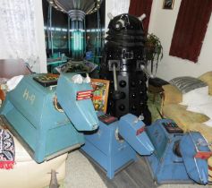 A Dr. Who series K9 full size, here pictured on the left