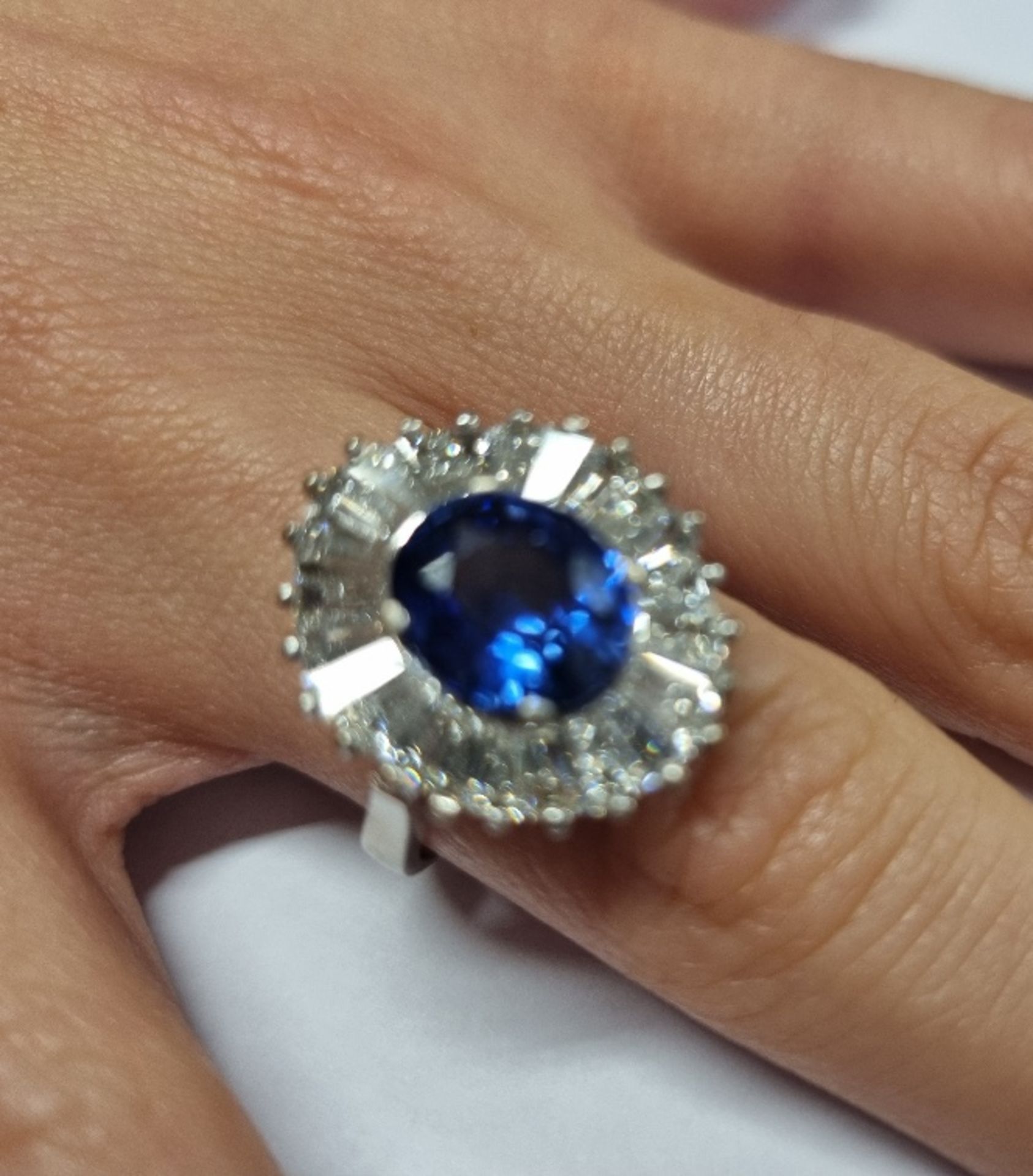 WHITE METAL (STAMPED 750) OVAL SAPPHIRE WITH TAPERED BAGUETTE DIAMOND BALLERINA CLUSTER RING