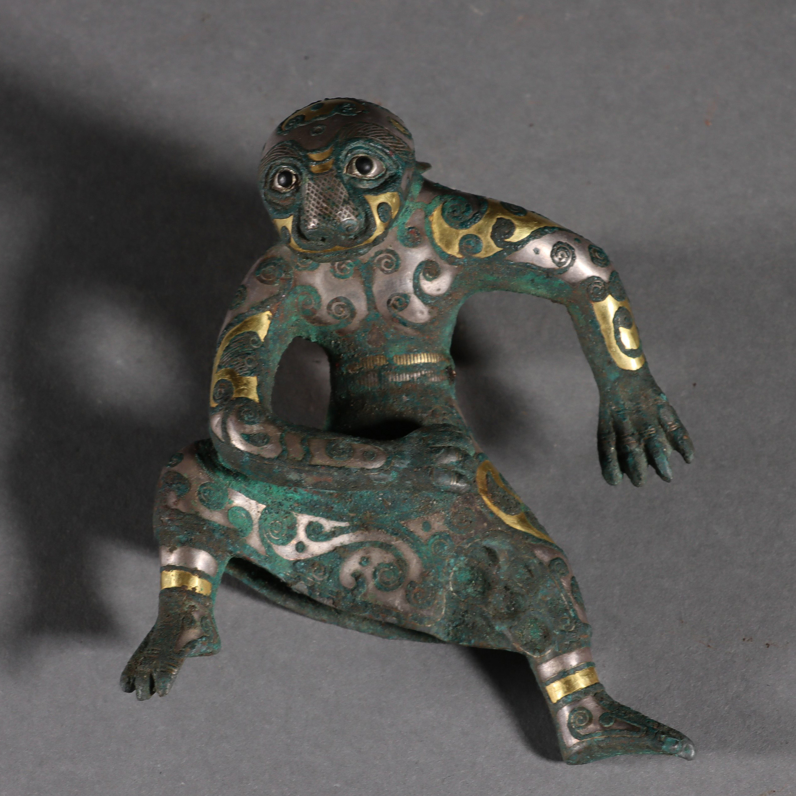 A Chinese Gold and Silver Decorated Bronze Beast