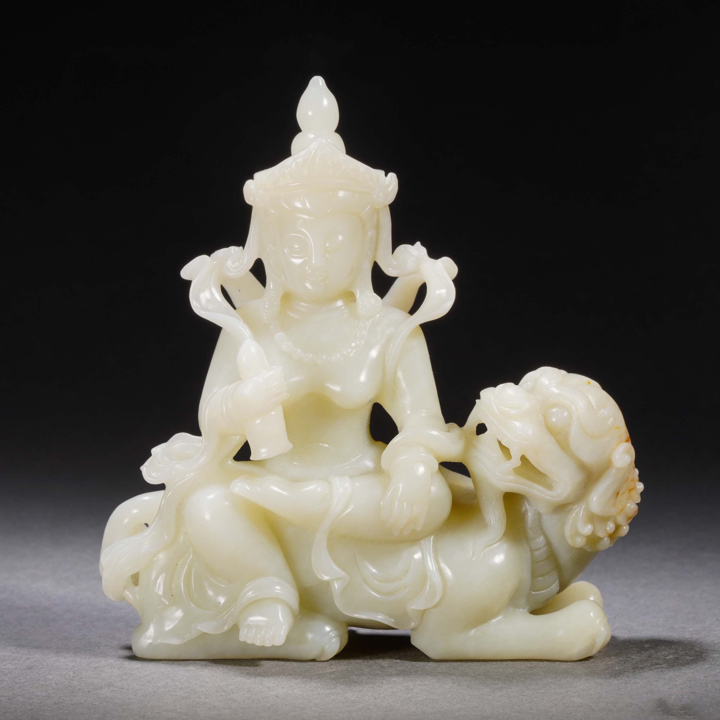 A Chinese Carved White Jade Bodhisattva with Lion