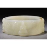 A Chinese Carved White Jade Buddha Bangle