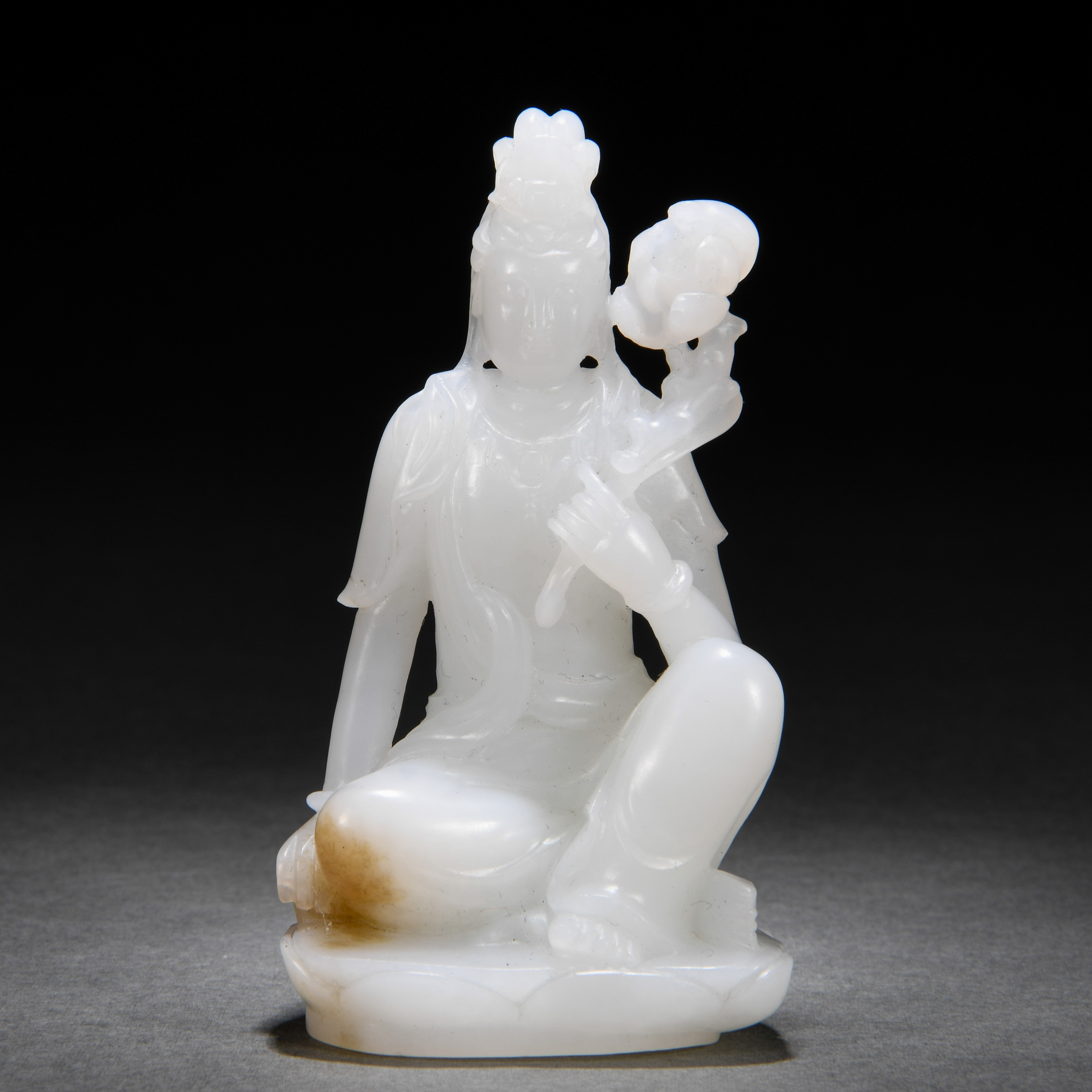 A Chinese Carved White Jade Seated Guanyin