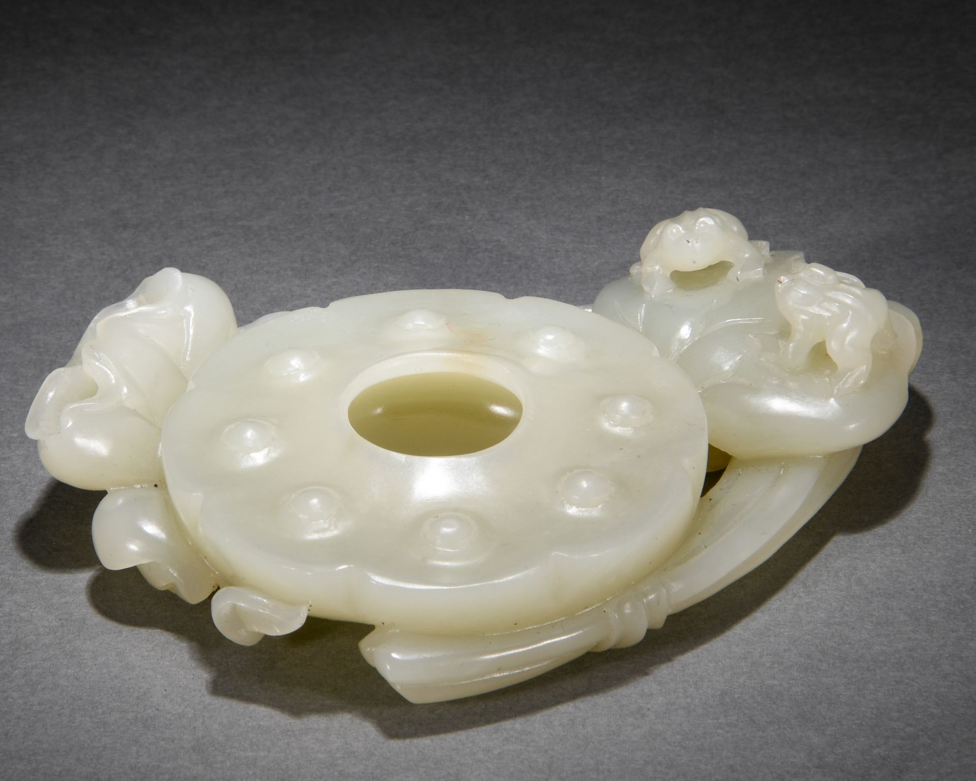 A Chinese Carved White Jade Washer