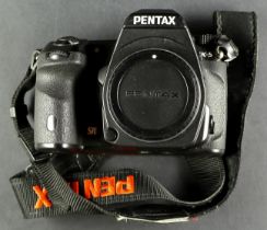 PENTAX K-5. A Pentax model K-5, comes in box which includes; owner's manual, battery, battery
