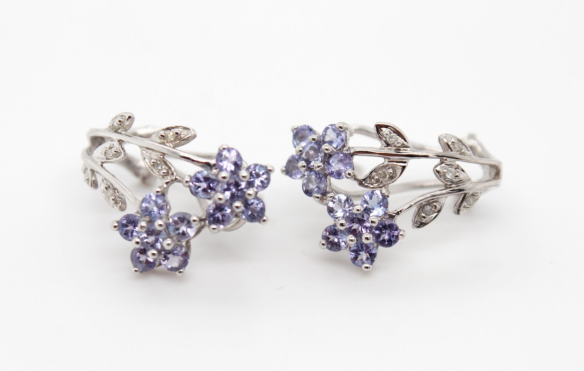 Stud earrings and a pendant with tanzanites and diamonds