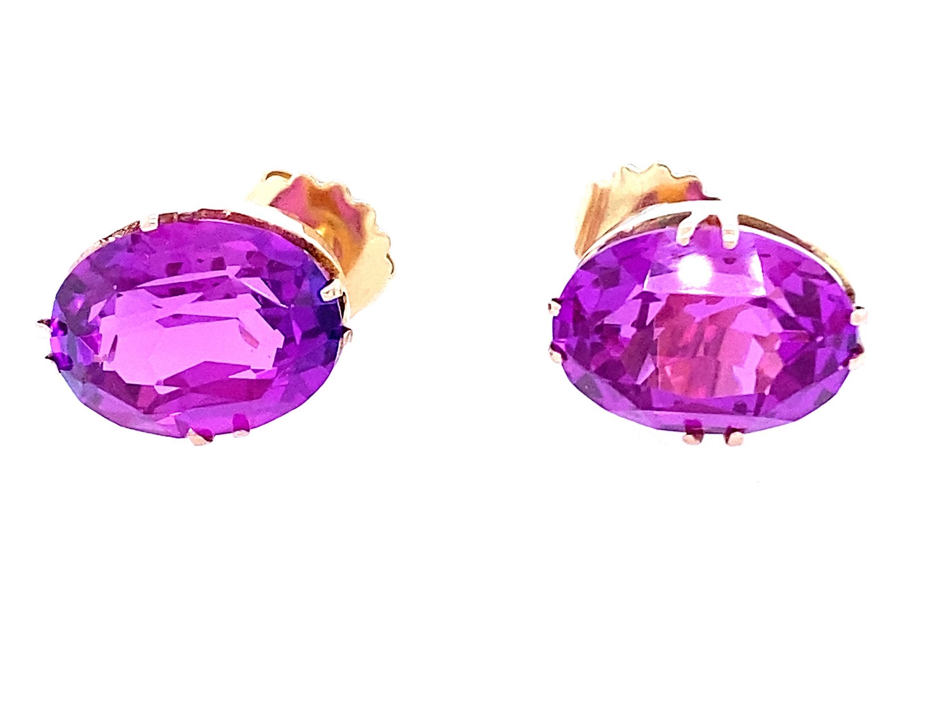1 pair of stud earrings with large purple pink synthetic sapphires