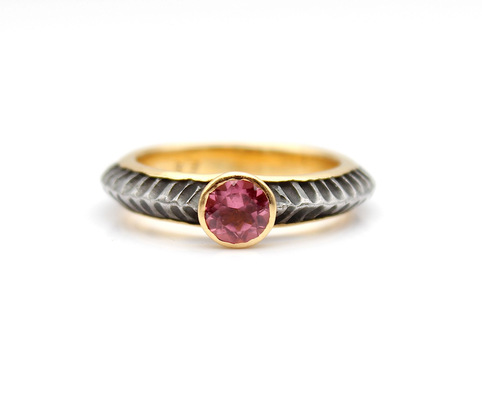 Stylish gold and iron ring with pink tourmaline