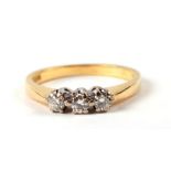 An 18ct gold ring set with three diamonds, approx UK size 'M', 3g.