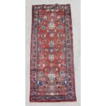 A Persian hand knotted runner with stylised flowers within multi borders, 280 by 105cms ((321).