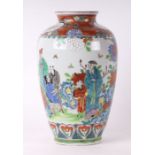 A Japanese baluster vase decorated with figures in garden scenes, red mark to the underside, 28cms