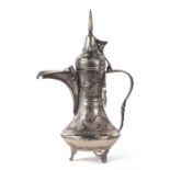 A Turkish / Islamic pierced silver coloured metal dallah coffee pot, 36cms high.