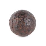 An early iron cannon ball, 8cms diameter.