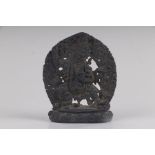 A small Tibetan bronze figure of Vajrapani surrounded by a mandorla, 8.5cms wide.