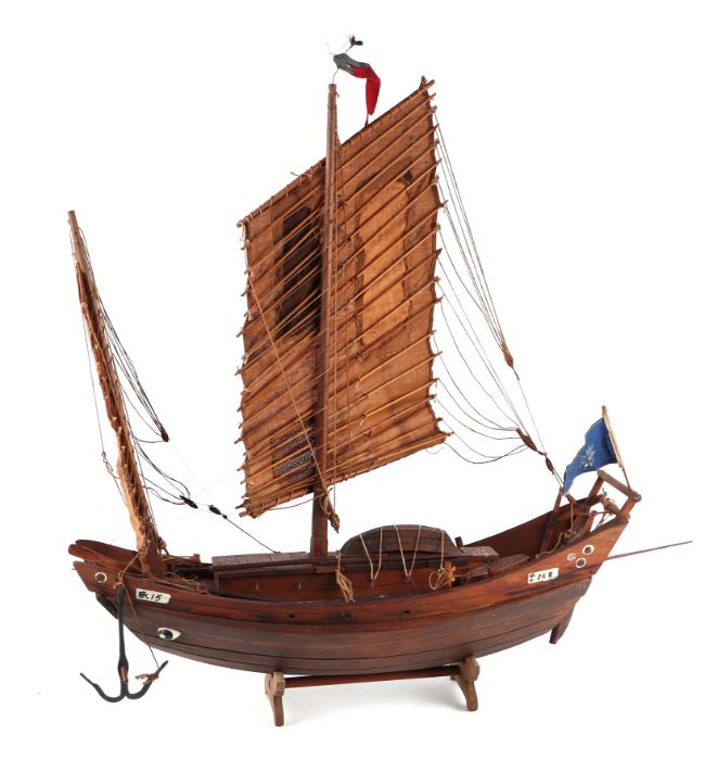 A Chinese wooden model of a junk on a stand, 43cms long.