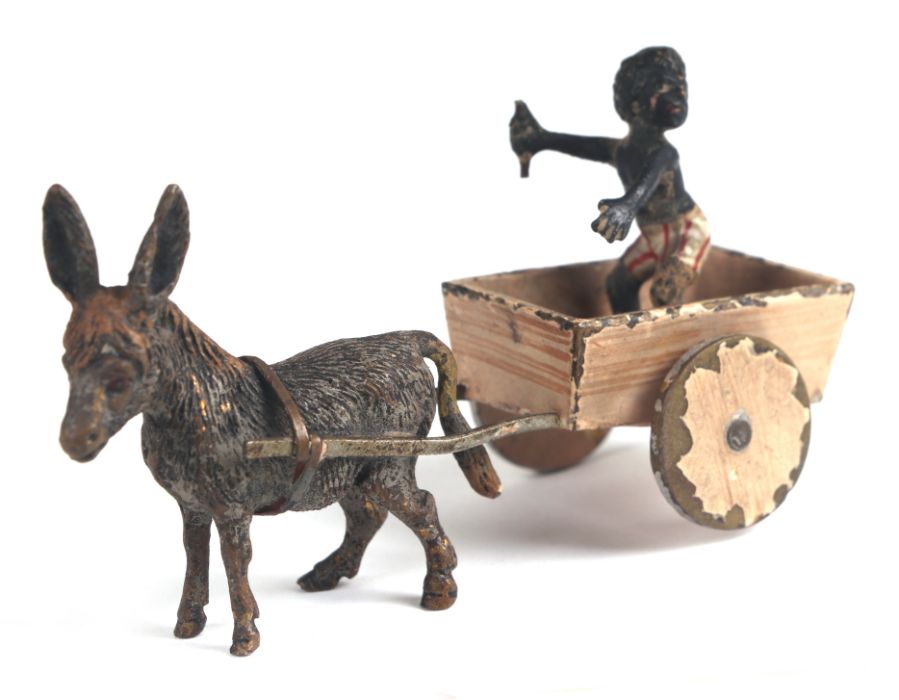 An antique novelty Vienna cold painted bronze group in the form of a black boy in a donkey cart,