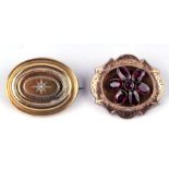 A Victorian yellow metal garnet set brooch with locket back, 3.5cms wide; together with a