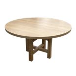 An oak circular dining table on four square legs, 140cms wide.