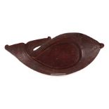 A New Zealand Maori carved hardwood dish in the form of a stylised fish, 47cms wide.