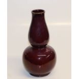 A Chinese sang de boeuf double gourd vase, 23cms high.Condition ReportThere is a small chip to the