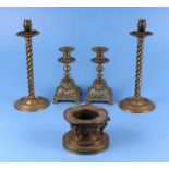 A pair of Victorian brass candlesticks on pierced square bases, 21cms high; together with a brass