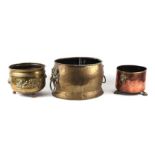 A large brass oval log bin with lion mask handles, 51cms wide; together with a copper planter and