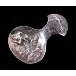 A 19th century Dutch white metal caddy spoon with repousse decoration depicting figures around a