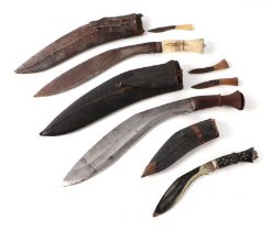 A Kukri with bone handle and leather scabbard, 40cms long; together with two similar (3).