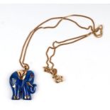 A 14ct gold mounted lapis lazuli pendant in the form of an elephant with a ruby eye, on a fine 9ct