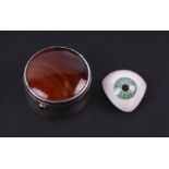 A prosthetic human glass eye in a late Victorian / Edwardian silver pill box with agate lid,