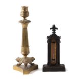 A Victorian cast iron desk thermometer, 21cms high; together with a Regency brass candlestick on