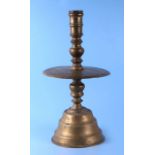 A 17th / 18th century Dutch bell bottom candlestick with ring turned column above a large circular