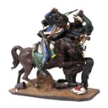 A cold painted spelter figural group of a 19th century cavalry officer and a Moorish soldier, both