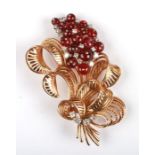 A large yellow metal (tests as gold) flower spray brooch set with diamonds and bead rubies, 6.5cms