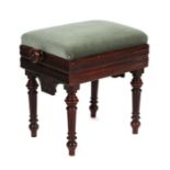 An Edwardian mahogany rise-and-fall piano stool with reeded and turned legs, 42cms wide.