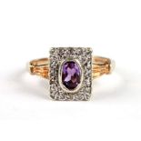 A 9ct gold panel ring with central amethyst within a diamond border, approx UK size 'L', 2.8g.